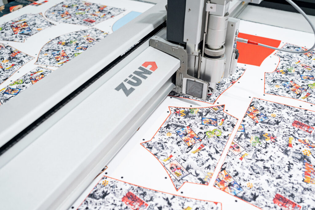 AOP fabric cut with a Zünd cutter at Snapwear's print-on-demand facility – precision cutting for custom apparel.